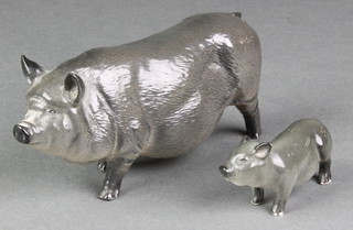 A Royal Doulton figure of a Vietnamese pot bellied pig 6 1/2", a ditto of a piglet 2 1/2" 