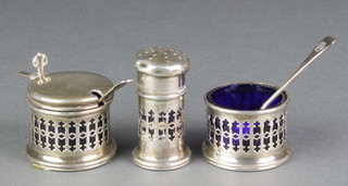 A silver 3 piece condiment with pierced decoration and blue glass liners with 1 silver and 1 plated spoon, Birmingham 1925, 1926 and 1931, 14 grams 