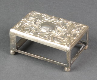 A Victorian repousse silver match box holder with floral decoration and vacant cartouche on ball feet, Birmingham 1900 3" 