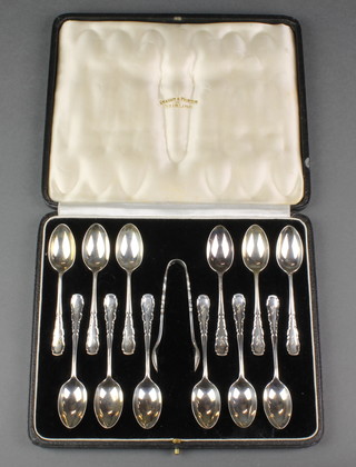 A cased set of 12 silver coffee spoons and nips with fancy handles and engraved monogram, London 1937, 78 grams