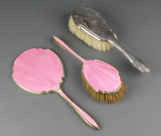 A silver and pink guilloche enamel hand mirror and hair brush Birmingham 1936/37 and a silver backed hair brush 