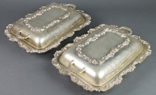 A pair of silver plated entree dishes with scroll decoration 12" 