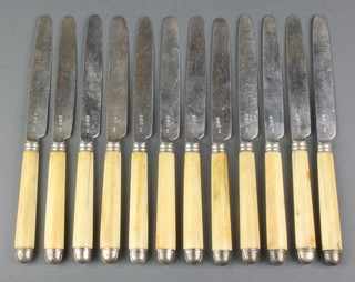 A set of 12 Georgian silver and ivory dinner knives with capped ends