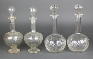 A pair of Edwardian mallet shaped decanters with faceted decoration 12", a ditto pair with hobnail decoration 11" 