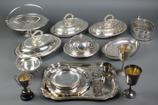 A silver plated repousse muffin dish, 3 plated entree sets and other plated items 
