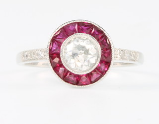 An 18ct white gold ruby and diamond target shaped ring, size O 