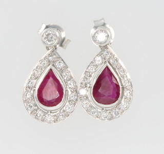 A pair of 18ct white gold ruby and diamond pear shaped earrings, the ruby approx. 1.6ct surrounded by 15 diamonds 