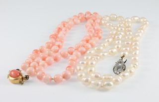 A coral necklace 18" and a cultured pearl ditto 18" 