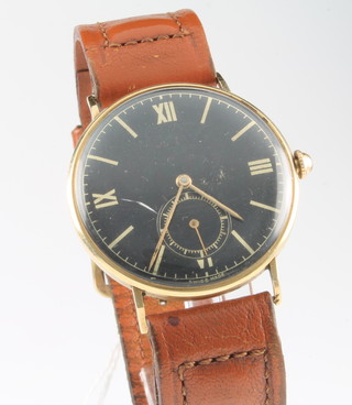 A gentleman's 18ct yellow gold Movado black dial wristwatch with seconds at 6 o'clock on a leather strap 