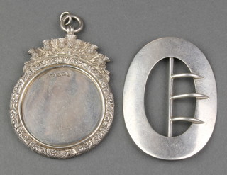 A Victorian oval silver buckle Chester 1887 and a cast silver medallion 