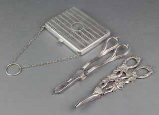 2 pairs of cast silver plated grape scissors and an engine turned silver plated purse 