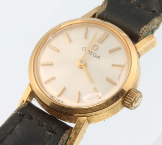 A lady's gilt cased Omega wristwatch on a leather strap 