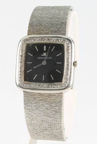 A lady's 18ct white gold Jaeger Le Coultre wristwatch the black square dial surrounded by 56 brilliant cut diamonds on an 18ct white gold bark finished bracelet, gross 67 grams 