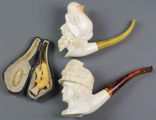 A Victorian carved Meerschaum cheroot holder in the form of a running dog 3 1/2" cased, 2 later carved Meerschaum pipes with mask bowls