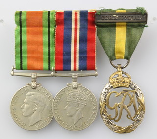 A World War II trio comprising Defence, British War and Territorial Decoration medal  
