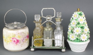 An Edwardian biscuit barrel with silver plated mounts, a 6 bottle cruet and a Continental porcelain table lamp base 