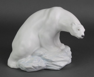 A Lladro figure of a Polar Bear sitting on a rock 8481 10" 