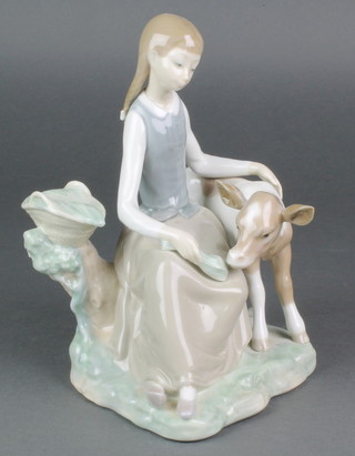 A Lladro figure of a young girl with calf 9" 
