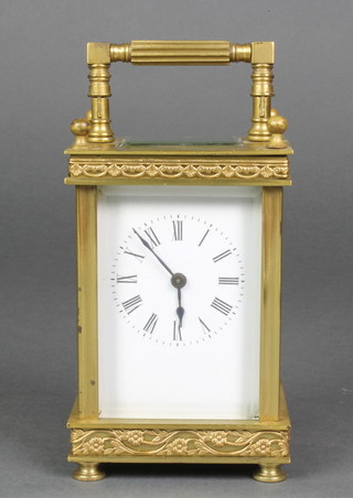 A 20th Century French 8 day carriage timepiece with enamelled dial and Roman numerals on turned feet, contained in a brass case  5"h x 3"w x 2 1/2"d 