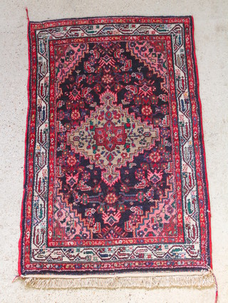 A blue and red ground Persian rug with central medallion 64" x 42" 
