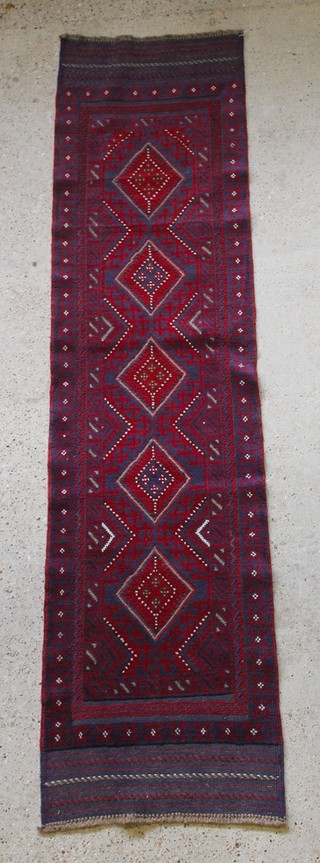 A contemporary red and blue ground Meshwani runner with 5 diamonds to the centre 99" x 25" 

