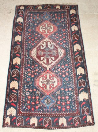 A Persian Qashqai rug with 3 diamonds to the centre 115" x 63", in wear  