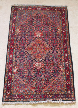 A Persian blue and red ground Tabriz rug, the central medallion within multi row borders 86" x  51" 