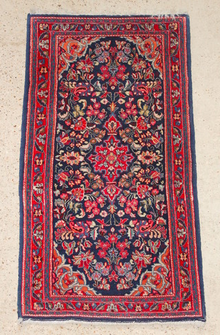 A red and blue ground Persian Sarough rug with floral ground 51" x 27" 