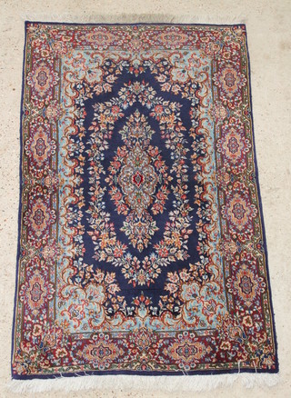A blue and floral ground Persian Kirman rug 64" x 40" 