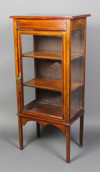 An Edwardian inlaid mahogany display cabinet, the interior fitted a shelf enclosed by glazed panelled doors, raised on square tapered supports 49"h x 23"w x 15"w 
