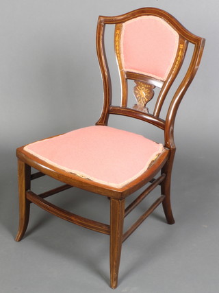 An Edwardian inlaid mahogany shield shaped bedroom chair, raised on square tapered supports 