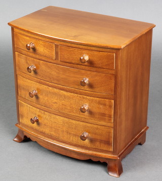A Victorian style apprentice bow front chest of 3 drawers with tore handles, raised on bracket feet 9"h x 8 1/2"w x 6"d 