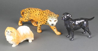 A Beswick figure of a standing leopard 8", a Sylvac figure of a Pekinese dog 3765 4" and a Royal Doulton figure of a black Labrador 7" 