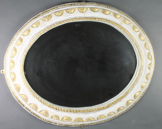 An oval plate wall mirror contained in a gilt and white painted carved frame 32"w x 39"h 