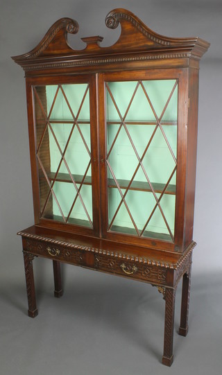 A Georgian mahogany Chippendale style display cabinet on stand, the upper section with broken pediment and dentil cornice, fitted adjustable shelves enclosed by astragal glazed panelled doors, the base fitted 2 long drawers raised on square supports, spade feet with fret decoration 79"h x 47"w x 15" (Made up)  