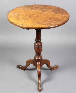 A 19th Century circular elm tea table raised on a turned column and tripod base 28"h x 23"w 