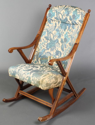 A Victorian mahogany show frame rocking chair with upholstered seat and back