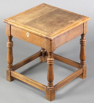An oak joined stool with hinged lid, raised on turned and block supports 16"h x 14 1/2" x 14"
