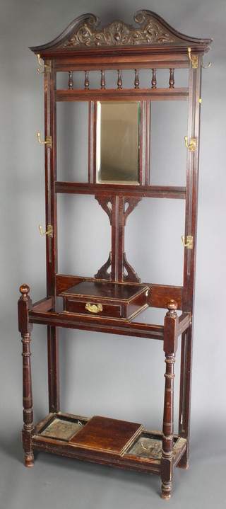 A Victorian walnut hall stand, the back fitted a rectangular plate mirror and 6 hooks, the base fitted a glove box with drawer, umbrella stand complete with drip tray, 77"h x 28"w x 12"d 