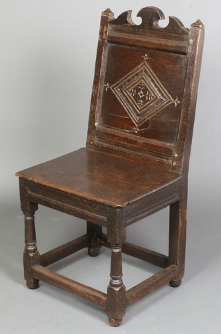 A 17th Century oak high back chair of joined construction raised on turned and block supports (with possible replacement feet) 