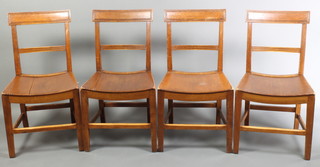 A set of 4 19th Century mahogany bar back dining chairs with shaped mid rails and saddle shaped seats, raised on square tapering supports