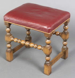 A 17th Century style rectangular oak stool raised on bobbin turned and block supports, the seat upholstered in red leather 13"h x 17"w x 14"d 