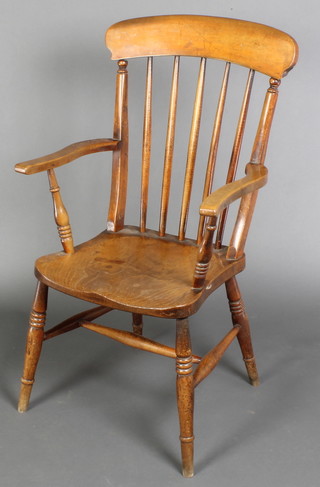 A 19th Century light elm Windsor stick and rail back chair with H framed stretcher, raised on turned supports, the base marked W L 56 
