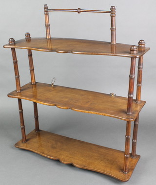 A Victorian rectangular 3 tier hanging wall shelf with bamboo supports 23"h x 20"w x 7"d 