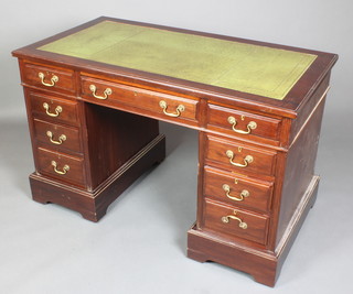 A 19th Century mahogany kneehole pedestal desk with green inset writing surface above 1 long and 8 short drawers 31"h x 48"w x 26"d 