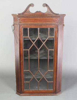 An Edwardian inlaid mahogany hanging corner cabinet with broken pediment, fitted adjustable shelves enclosed by astragal glazed panelled doors 45"h x 24 1/2"w x 14"d 