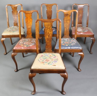 A set of 6 Queen Anne style walnut dining chairs with upholstered Berlin wool work drop in seats, raised on cabriole supports 