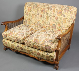 A 1920's carved mahogany 3 piece single cane bergere suite comprising a 2 seat sofa and 2 armchairs 