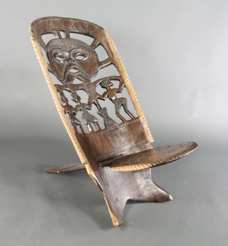 An African carved and pierced hardwood tub back chair with solid seat 37"h x 36"w