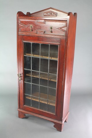 A 1920's oak Jacobean style bookcase with geometric mouldings, the raised back with three-quarter gallery fitted a drawer above a cupboard, fitted adjustable shelves enclosed by lead glazed panelled doors and raised on bracket feet 53"h x 24"w x 10"d